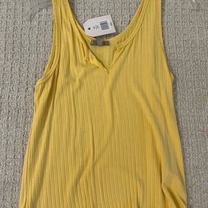 Yellow tank top. V neck cut.